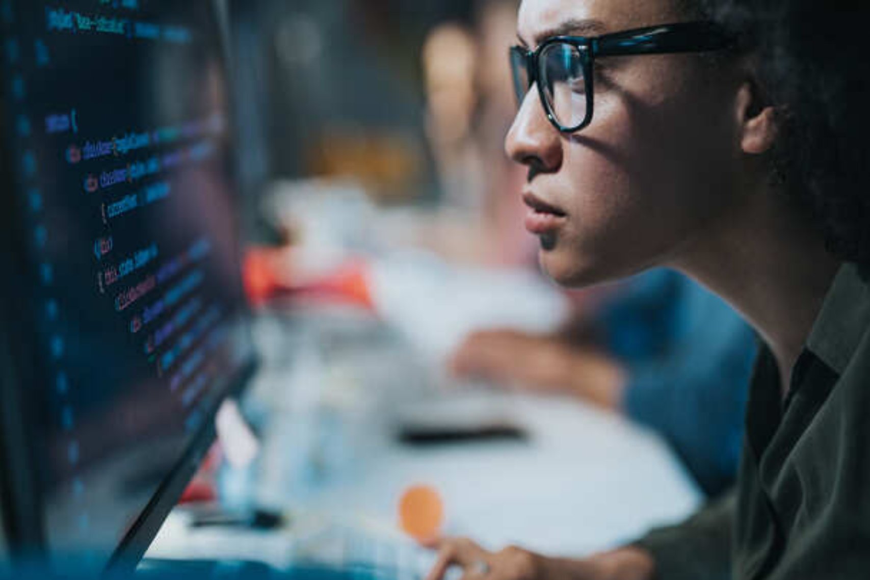 Accenture man with glasses programming